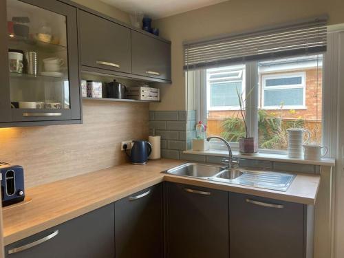 a kitchen with a sink and a window at Number 3 in Penrhyn Bay