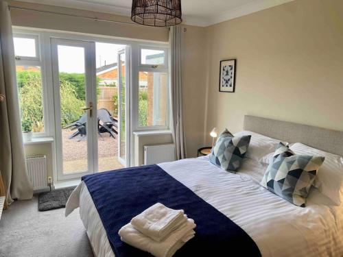 a bedroom with a large bed with blue and white sheets at Number 3 in Penrhyn Bay