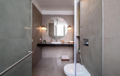 a bathroom with a sink and a toilet and a mirror at El Rocio Estate 2bhk in Assagao with Common pool, Free Parking,8 min away from Vagator in Assagao