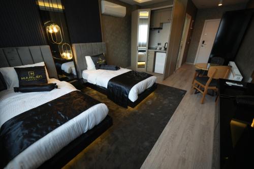 a hotel room with two beds and a kitchen at Marlen Hotel Bayraklı in Bayrakli