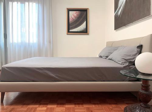 a bedroom with a bed and a table and a window at Mini Suite Cremona in Cremona