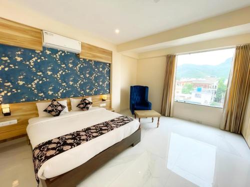 a hotel room with a bed and a window at HOTEL THE CELEBRATION BY AMOD Best Hotel & Rooftop in Udaipur