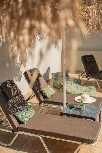 a wooden table with chairs and a tableasteryasteryasteryasteryasteryasteryasteryastery at Natali Apartments by Estia in Malia