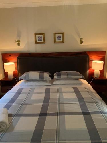 una camera da letto con un letto grande con due lampade di REDGUM RETREAT BRIGHT - Luxury Spa Villa a Bright