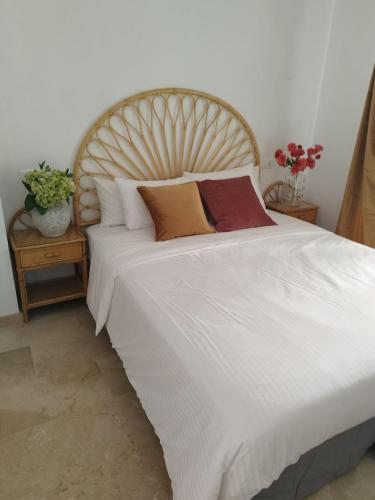 a bedroom with a large white bed with pillows at Balay Apartment Benidorm in Benidorm