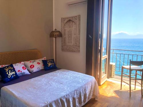 a bedroom with a bed with a view of the ocean at B&B Vista Mare in Naples