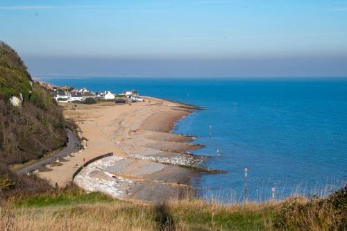 a view of a beach with houses and the ocean at Pilots Lodge by Deal Castle with free parking in Deal
