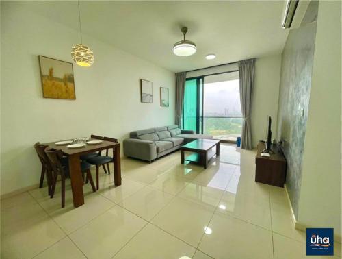 a living room with a table and a couch at Macrolink Medini by RR JBcity in Nusajaya