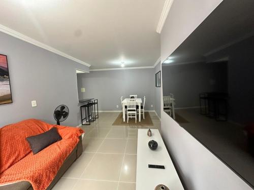 Sala de estar con cama y mesa en Suites W-Riocentro, en Río de Janeiro