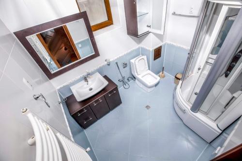 an overhead view of a bathroom with a toilet and sink at PANORAMA VILLA 5 MIN. TO NIZAMI STREET in Baku