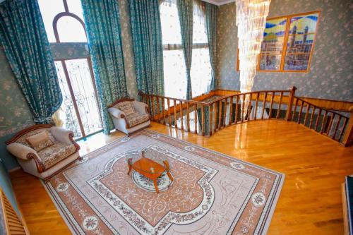 a living room with a table and some chairs at PANORAMA VILLA 5 MIN. TO NIZAMI STREET in Baku