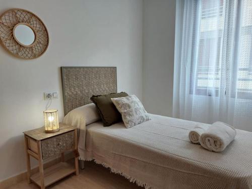 1 dormitorio con cama con espejo y mesa en Vistas al mar en Canet Playa WIFI, en Canet de Berenguer