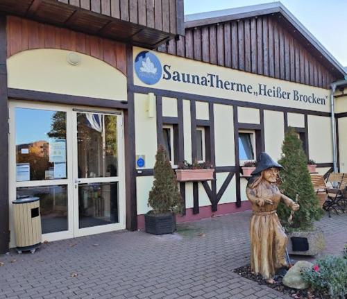 a statue of a woman standing in front of a building at Utuwe in Altenau