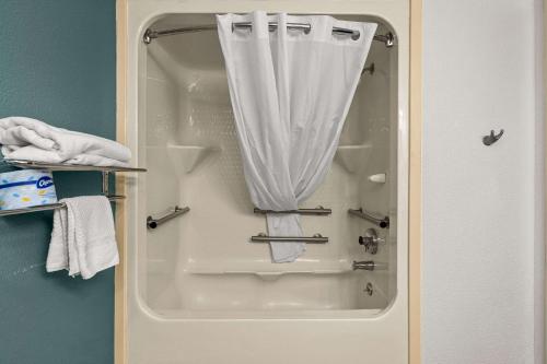 a shower with a white curtain in a bathroom at Sleep Inn in Wilmington