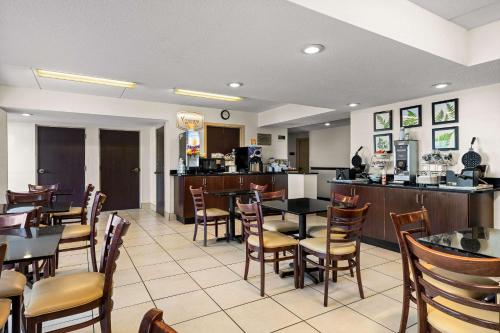a restaurant with tables and chairs and a bar at Sleep Inn in Wilmington