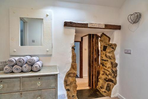 a room with a mirror and a dresser at Finest Retreats - Heath Hills in Okehampton