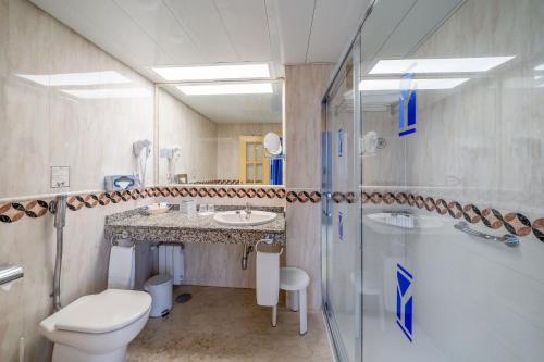 a bathroom with a toilet and a sink and a shower at Hotel Yaramar - Adults Recommended in Fuengirola