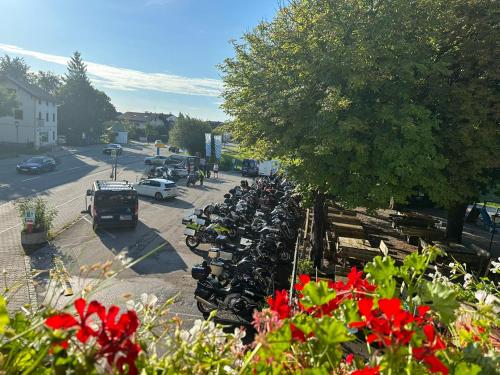 a row of motorcycles parked in a parking lot at Hotel Alter Wirt in Weyarn