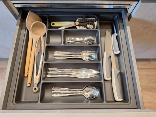 a tray filled with utensils in a drawer at Meridian A23 in Reggio Emilia