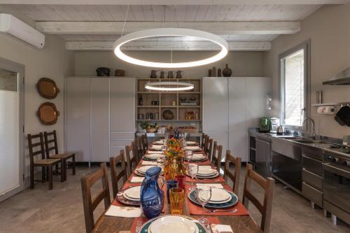 a long dining room with a long table and chairs at Agriturismo Corbaia Relais in Santa Lucia di Roversano