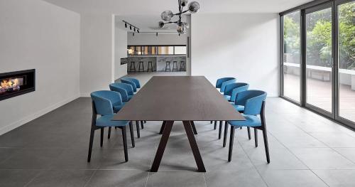 a conference room with a table and blue chairs at Luxury Living, Richmond in Melbourne