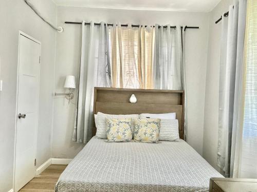 a bedroom with a bed and a window at Healing in the City in Montego Bay
