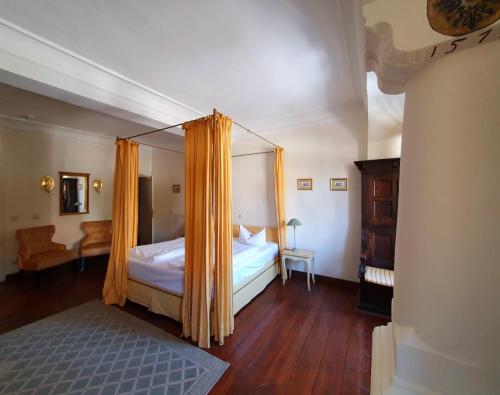a bedroom with a bed with a canopy at Hotel Adler in Rudolstadt