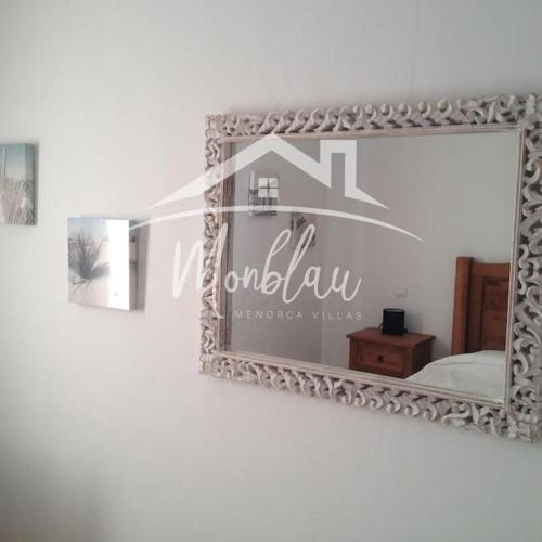 a mirror on a wall in a room at SA TANCA in Cala Blanca