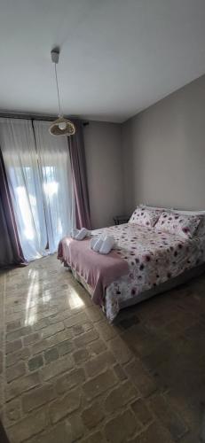 a bedroom with a bed in a room with windows at "il Casaletto" Agriturismo Moderno, Vista Panoramica e Cibo Spettacolare- Scurcola Marsicana in Scurcola Marsicana
