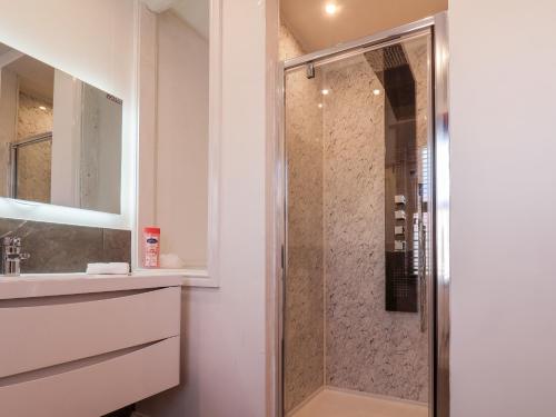 a shower with a glass door in a bathroom at 8 Post Office Street in Bridlington