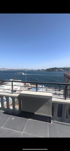 a bench on top of a building with a view of the water at Maison de rève in Istanbul