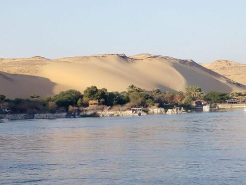a view of a body of water with sand dunes at Nile Felucca Adventure in Aswan