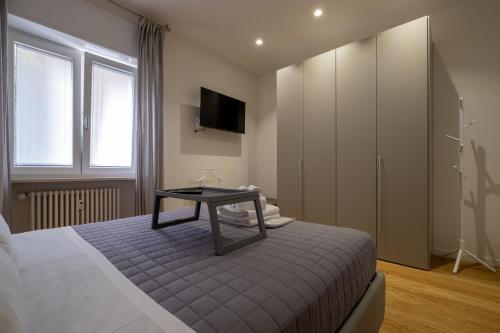 a bedroom with a bed with a table on it at Veroniamo in Verona