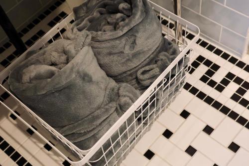 a baby sitting in a laundry basket at THE ROOT2 HOTEL in Kyoto