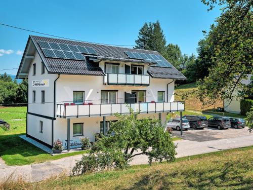a house with solar panels on the roof at Apartment Elisabeth by Interhome in Egg am Faaker See