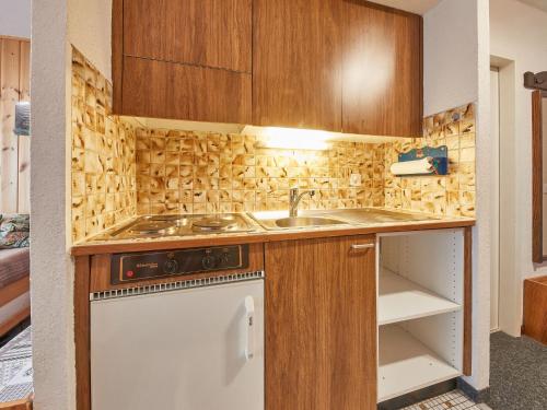 a small kitchen with a sink and a stove at Apartment Greppon 306 by Interhome in Les Collons