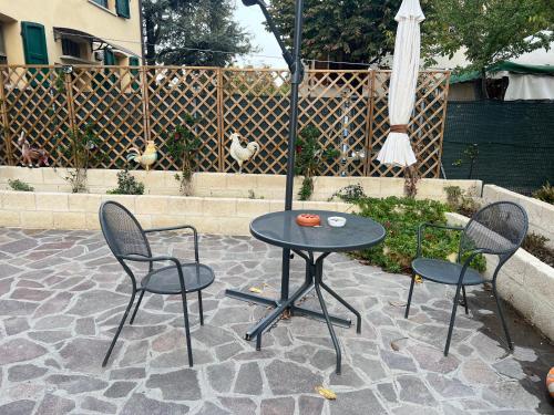 a patio with a table and two chairs and an umbrella at ANGI B&B in Budrio