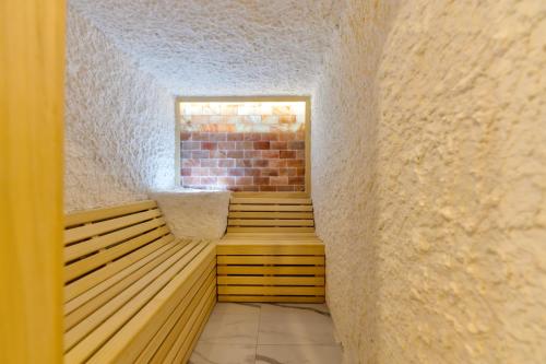 a room with a sauna with a brick wall at Apartman Zelenbor 4 Vila Zlatibor Luxury&Spa in Zlatibor