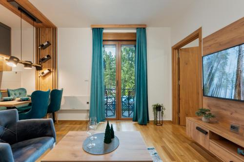 a living room with a couch and a table at Apartman Zelenbor 4 Vila Zlatibor Luxury&Spa in Zlatibor