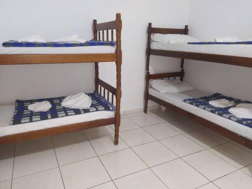 2 łóżka piętrowe w pokoju z podłogą wyłożoną kafelkami w obiekcie Grandes Grupos Casa 2 w São Paulo