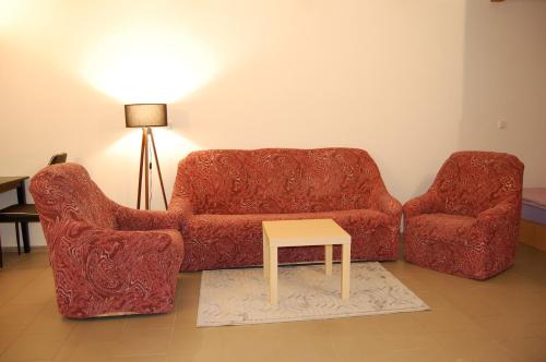 a living room with a couch and a table at Ubytování U Vítů in České Chaloupy