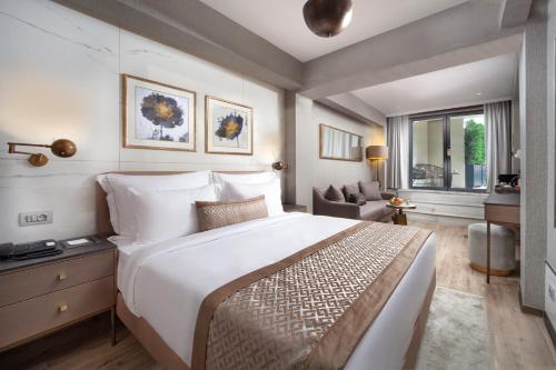 a hotel room with a large bed and a chair at Mula Hotel in Istanbul