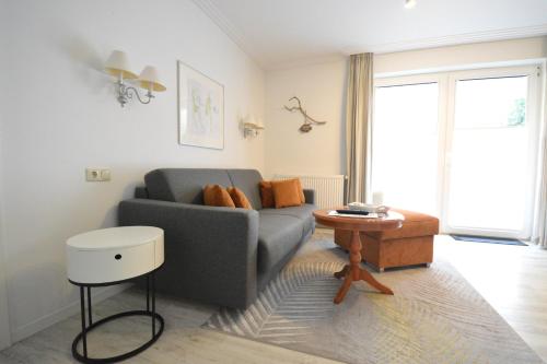 a living room with a couch and a table at Appartement-Villa Steinfurth in Binz
