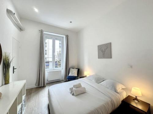 une chambre blanche avec un grand lit et une fenêtre dans l'établissement Cosy appart - lyon 6 - Gare Partdieu - Lafayette 1, à Lyon