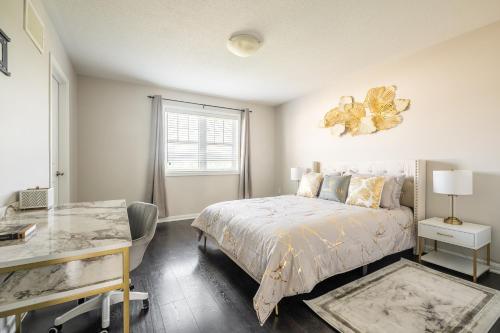 a bedroom with a bed and a desk and a window at GLOBALSTAY Modern 3 Bedroom House in Brampton in Brampton