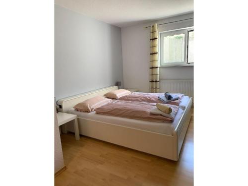 Schlafzimmer mit einem Bett und einem Fenster in der Unterkunft Ferienwohnung Emilia in Münsingen