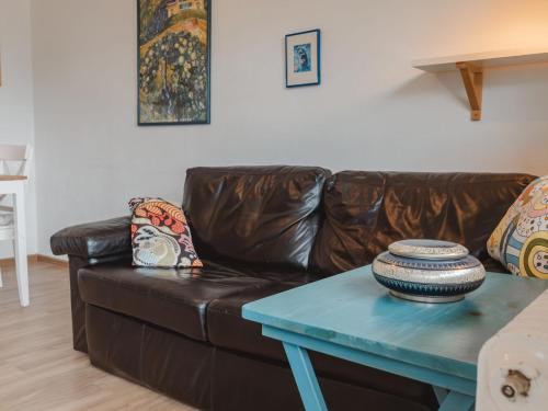 een woonkamer met een leren bank en een tafel bij Apartment Smilla by Interhome in Bad Gastein