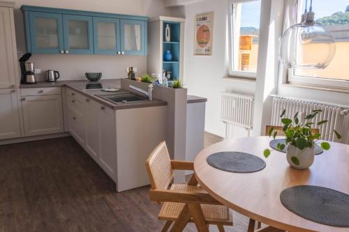 a kitchen with a table and a dining room at Apartment am Kurpark mit traumhafter Terrasse in Bad Ems