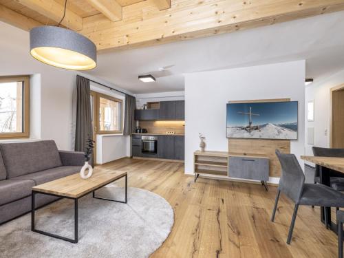 a living room with a couch and a table at Apartment Penthouse small 18 by Interhome in Söll