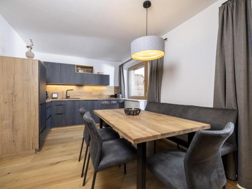 a kitchen and dining room with a wooden table and chairs at Apartment Apartments Austria-18 by Interhome in Söll